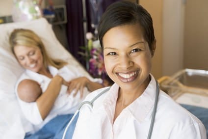 Doctor Standing In Her Patients Room,Woman Holding Baby