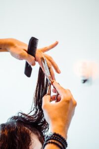 woman holding hair brush while putting her hand on her face