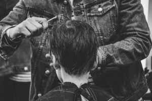 person cutting boy's hair